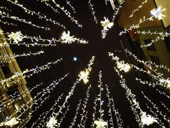 Low angle view of illuminated street light at night