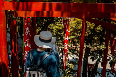 Rear view of man standing against trees