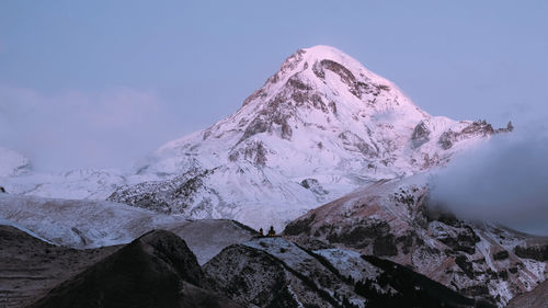 Scenic view of snowcapped mountains against clear sky