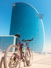 Low angle view of ferris wheel against building