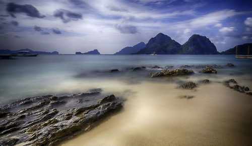 Scenic view of sea against cloudy sky