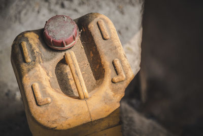 High angle view of dusty container by wall