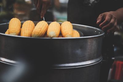 Close-up of man preparing food at market stall