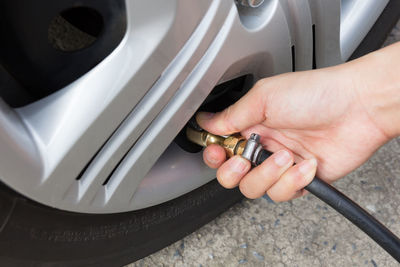 Cropped hand of man driving car