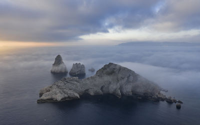 Aerial view of the medes islands in a foggy sunrise over the costa brava coast and mediterrania sea