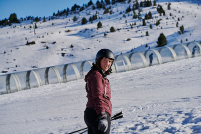 Smiling woman climbs the runway in a skier tape