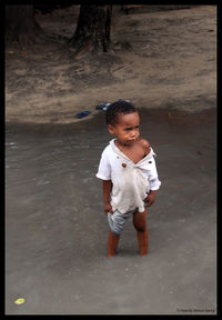 Boy standing in water