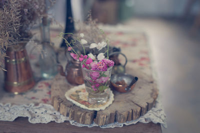 Close-up of pink roses in glass vase on table