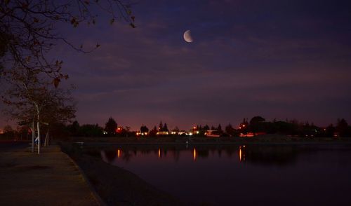 Scenic view of river against sky at dusk