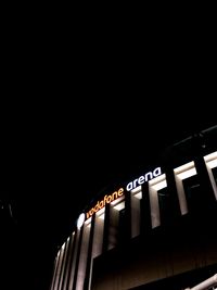 Low angle view of illuminated building against clear sky at night