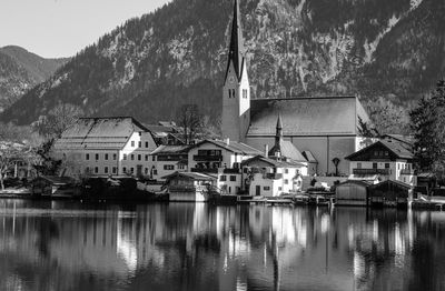 Houses by lake against sky