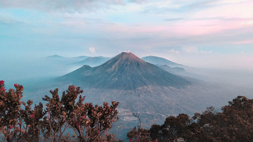 Scenic view of mountains against cloudy sky