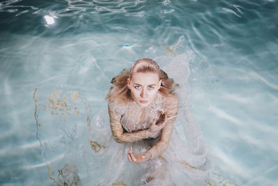 Portrait of young woman in swimming pool