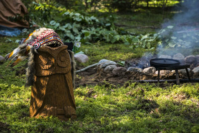 Tribal headwear on owl sculpture at campsite