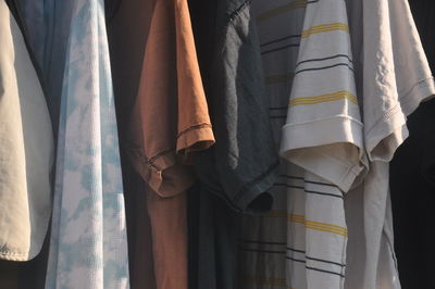 Close-up of clothes hanging on curtain