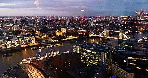 High angle view of illuminated city buildings against sky