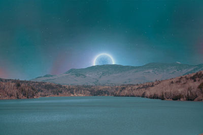 Scenic view of mountains against sky at night