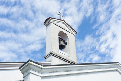 Low angle view of bell tower against sky