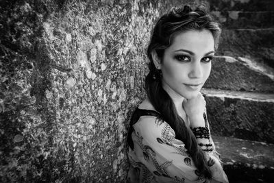 Portrait of young woman with tree trunk