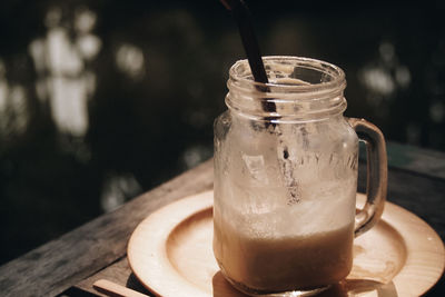 Close-up of coffee in glass jar on table