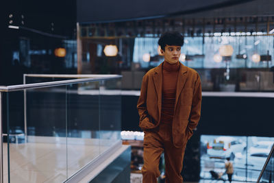 Portrait of young man standing in city