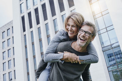 Portrait of a smiling young couple standing outdoors