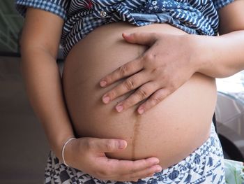 Close-up of woman touching hands