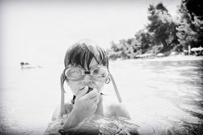 Portrait of shirtless boy swimming in sea