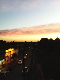 Cars on road in city against sky