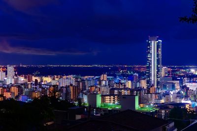 High angle view of illuminated buildings against sky at night