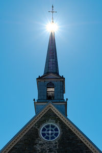 Low angle view of cross on building against sky