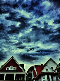 Low angle view of houses against cloudy sky