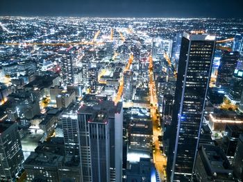 High angle view of illuminated buildings in city at night