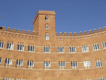 Low angle view of building against clear blue sky