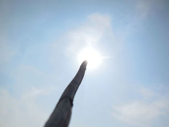 Low angle view of hand against sky