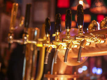 Close-up of beer taps at bar