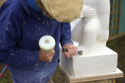 Sculptor chiseling stone