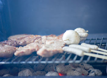 Close-up of meat with mushrooms on barbeque