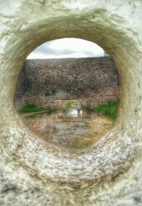 Low angle view of hole in tunnel