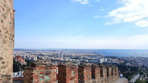 High angle view of city against blue sky