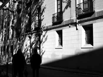 Rear view of man walking on zebra crossing