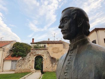 Statue of historic building against sky