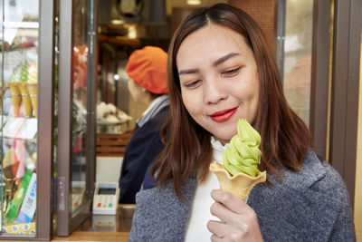 Portrait of woman holding ice cream