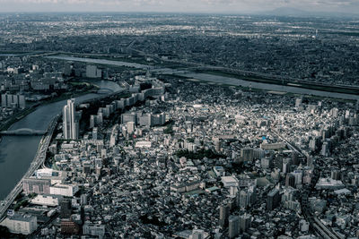 Aerial view of city and buildings against sky