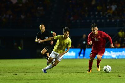 People playing soccer ball on grass