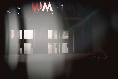 Reflection of illuminated lights on glass window