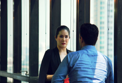 Businesswoman with male colleague in office during meeting