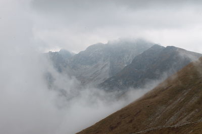 High angle view of mountain range against sky in foggy weather