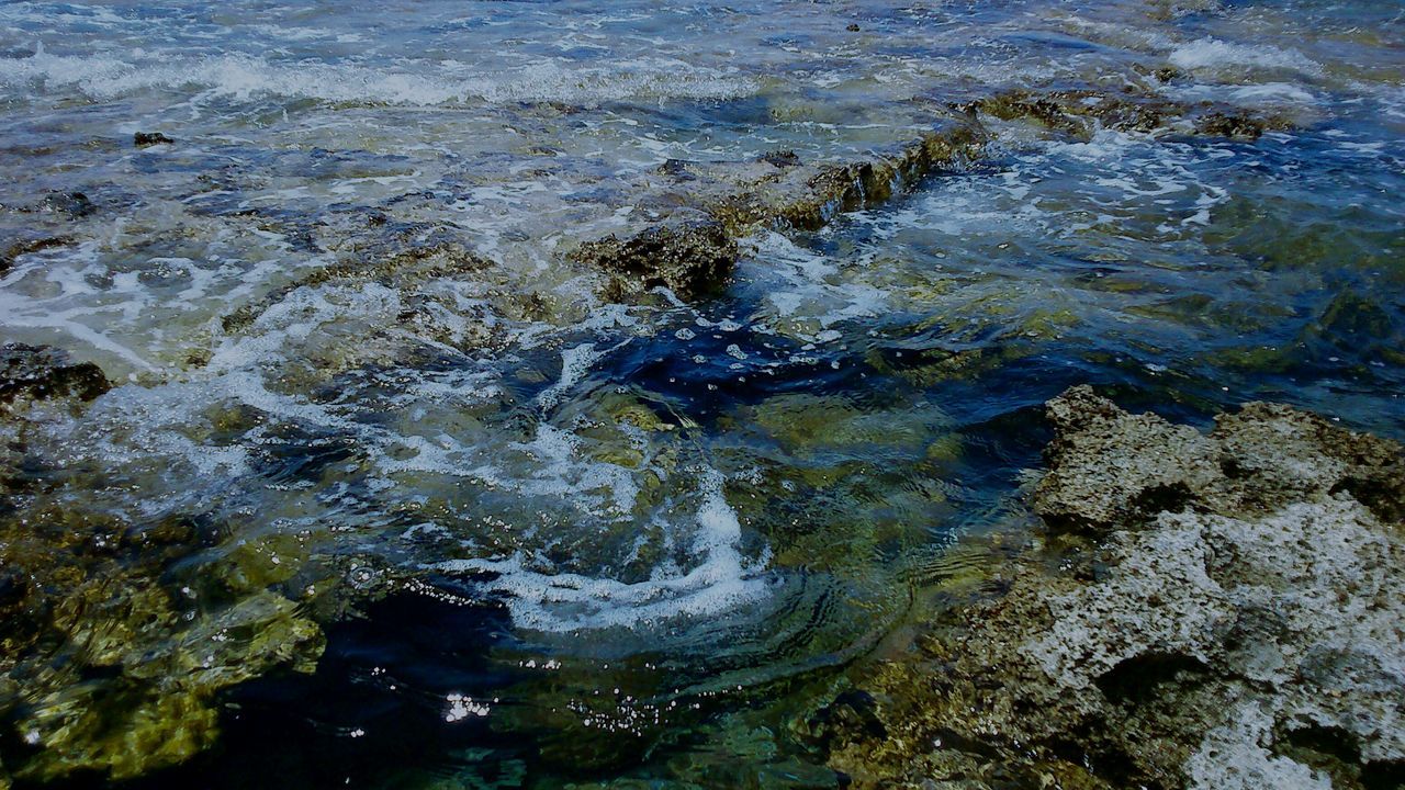 water, high angle view, nature, beauty in nature, wet, rock - object, motion, rippled, surf, tranquility, full frame, reflection, outdoors, day, backgrounds, sea, no people, waterfront, wave, purity