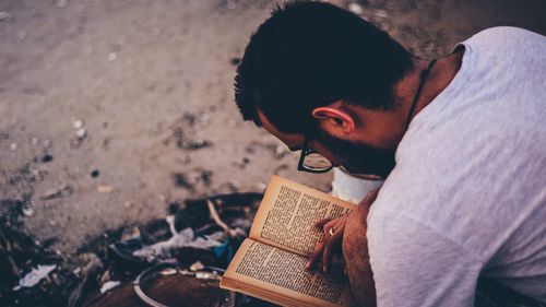 High angle view of man reading book